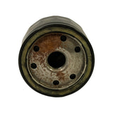 Threaded base plate of the spin-on filter viewed end-on: seven small inlet holes around a central M20x1.5 threaded outlet, light surface oxidation across the steel base typical of stored stock.
