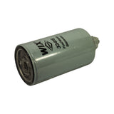 Reverse angled view: open mounting-thread end of the filter on the left, petcock drain valve at the right end, full body label visible
