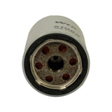 Bottom (mounting) end of filter. Central threaded port surrounded by six evenly spaced inlet/bypass holes in the steel base plate. Black rubber sealing gasket around the rim. Light surface oxidation on the base plate consistent with shelf age.