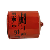 Side view of filter laid horizontally showing the brass water-drain spigot protruding from the lower sidewall, with printed installation pictogram instructions below the label