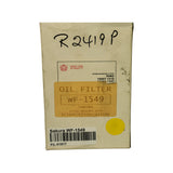 Front of aged cream cardboard box, pink Sakura cherry-blossom logo and 'SAKURA' text on white label, 'OIL FILTER WF-1549' on a tan rectangular sticker, 'R2419P' handwritten in marker across the top, Hino interchange sticker reading '15607-1410 / 15607-1220', lower sticker line reads 'INTERCHANGABLE WITH R2390P/R2506P/R2419P', yellow round inspection dot, mild surface scuffing and edge wear