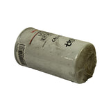 Filter laid on its side showing length, full label panel from a low angle, threaded base end at right under cellophane, dirt and shelf grime evident on the painted can