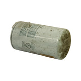 Filter laid horizontally on its side showing bilingual English/French assembly instructions printed on the can: 'ASSEMBLY INSTRUCTIONS' and 'INSTRUCTIONS DE MONTAGE', plus the 'ATTENTION A BENT OR DAMAGED FILTER MAY RUPTURE' warning icon