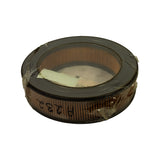 Underside view showing the annular/donut shape: pleated paper element forming a ring around a central air inlet opening with an instruction slip resting inside; handwritten 'A232' visible on the side of the element