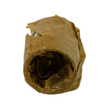 End-on view of bearing set in waxed paper wrapper. Hollow cylindrical form confirmed; inner bore visible through open end of wrapping.