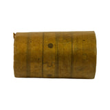 Bearing set in VCI waxed paper wrap, side view showing cylindrical form with multiple bearing rings stacked inside the roll. Curved split-lines of individual shell bearings visible through translucent wrap. Two oil holes visible.