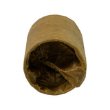 End-on view of the cam bearing bundle showing the open hollow bore, VCI paper folded inward. Individual bearing shells visible through the bore opening.