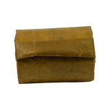 Cam bearing bundle shown at slight angle, flat side face visible with faint handwritten markings. Paper wrap intact on this face.