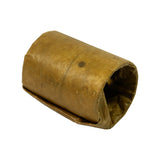 Angled view of cam bearing bundle resting at low angle, showing bore opening and full outer wrap. VCI paper wrap largely intact with minor creasing.