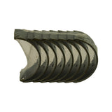 Close-up of bearing half-shells viewed from concave face side. Shells stacked and fanned, silver/lead overlay bore surface visible, dark steel-backed outer face. Still in original poly wrap.