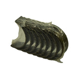 Alternate three-quarter view of bearing stack from opposite side, showing steel backing outer surface and locating tangs; NOS condition, no scoring or wear marks.