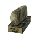 Angled side view of bearing set sitting atop closed box, still in translucent factory plastic wrap. Box end label visible showing '5M8353-.25' and 'MS1802AL 7204M'. Box corners show crushing and age wear.