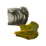 Reverse angle showing journal shell stack (clear wrap, left) and thrust bearing (yellow wrap, right). Copper backing clearly visible on one shell in the journal pack.