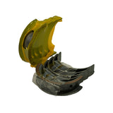 Top-down overhead view with bearing set split into upper and lower halves laid open on the yellow plastic holder. Copper alloy overlay visible on inner bore surfaces; oil hole visible in lower shell.
