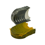 Rear-angle view showing the dark steel back of the upper shell stack and the ribbed outer surface of the yellow lower shell stack, demonstrating the two-piece upper/lower construction. Plastic wrapping partially visible.