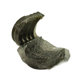 Underside angle of upper shell fan showing outer steel back and locating tangs. Lower shell bundle visible below, still wrapped.