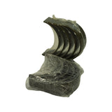 Angled overhead view of upper shells fanned open with lower shell bundle beneath. Both sets remain in original plastic wrapping. Inner bearing surface shows dark bimetal lining in good condition.