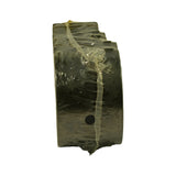 Edge-on view of the bearing set bundle wrapped in clear polythene, showing the flange profile and a single oil hole visible on one shell. Width of shells visible.