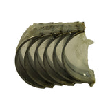 Opposite fan view of the bearing half-shells, bearing face side visible, wrapped in clear polythene. Five shells clearly visible in this angle, steel-backed outer face showing through wrapping.