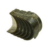 Second three-quarter view from opposite side showing outer steel-backed face of bearing shells with clear polythene wrapping, crush tabs visible at both ends of the half-shell arc.