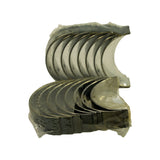 Both stacks fanned out face-up to show full set of inner bearing surfaces — AluminumSilicon overlay with characteristic grey-silver finish. Oil holes visible on upper halves. All 8 pairs represented.