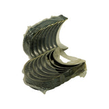 Both stacks angled to show outer steel back surfaces — dark grey steel finish visible along edges. Plastic film partially peeled from some shells.