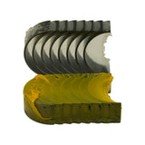 Alternative angle of both shell stacks fanned out, emphasising the semi-circular arc and the contrast between the dark upper halves and yellow-coated lower halves. All shells still in factory wrapping.