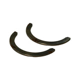 Side-on angled view of both steel-backed washers showing thin profile and curved form. Additional stamping partially readable on inner edge.