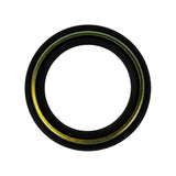 Oil-side face of bare oil seal laid flat, showing yellow-gold zinc-phosphate coated metal shell prominently visible as a bright band around the inner circumference, with black rubber lip extending inward.