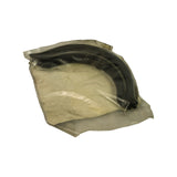 Side/top view of bag showing arc profile of one rubber sump end seal through packaging, resting on card backer.