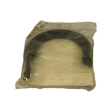 Sealed polybag viewed from front at slight angle, U-shaped seal visible through translucent bag alongside yellowed paper card insert. Packaging shows minor yellowing consistent with age.