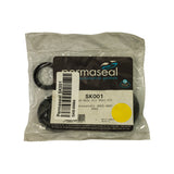 Front of sealed Permaseal retail polybag showing dark card header with Permaseal logo and 'automotive gaskets' tagline, asbestos-free badge, part number SK001, partial application text reading 'am Belt Oil Seal Kit / Mitsubishi 4G63, 4G67 / DOHC', batch code 138879 dated 18/07/11, EAN barcode 9419070131902, and AA Gaskets / NZ Gaskets contact footer. Retailer stock label overlaps upper-left of header card.