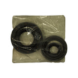 Contents of kit laid flat inside opened poly bag — two rubber lip seals: one large-diameter (crankshaft front/rear) and one smaller-diameter (auxiliary/balance shaft), both individually wrapped in clear film, showing difference in bore sizes between the two components.