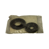Kit contents viewed from above inside original bag, showing both seals (large and small) in loose clear wrapping; packaging bag shows age-related yellowing and light surface wear consistent with NOS storage since 2007.
