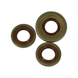 Three seals arranged face-down showing rear faces. Faint stamped markings visible on rubber lip faces of all three seals. Slight surface oxidation on outer steel shells consistent with shelf age.
