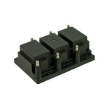Isometric view from front-right. Three coil towers with HT terminal pairs visible. Six LT signal pins along base. Two mounting holes on base flange. Part condition appears new and unused.