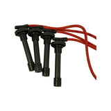 Close-up of the four spark plug boot ends, straight black rubber boots with tubular silicone wire. Faint 'HIGH PERFORMANCE CABLE' text visible on red wire sheathing.