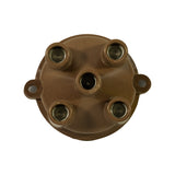 Top-down view showing interior of cap: four outer HT contact seats with brass/copper contacts, central carbon brush contact visible in centre bore. Two side mounting tabs visible. Contacts appear clean and uncorroded.