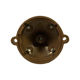 Bottom (interior) view of cap showing four internal contact blades (steel/copper) positioned around the central post. Moulded legend visible reading 'Made in England'. A small moulded marking also visible near base — appears to be a batch or tooling code.