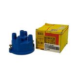 Part and original Bosch yellow-and-red box side by side. Box label reads 'BOSCH PACKED DISTRIBUTOR CAP GL 961' with additional codes including '70034', '7P-5', '206225-14', and handwritten annotation '4 Cylinder'. NZ Auto Supply SKU label affixed to box face.