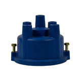 Front elevation of cap showing all five towers (four HT lead towers plus one central coil tower), flanged base with two brass screw-type retaining clips on opposite sides.