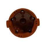 Bottom-up view of the open base of the cap showing interior: central carbon brush contact point, six internal electrode contacts (silver-coloured), moulded ribs and locating features. No visible cracks or carbon tracking inside; part appears unused.