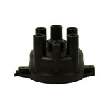 Front elevation of cap showing five towers arranged around central coil tower. Latch clip mechanism visible centre-front. Flat octagonal base flange with two screw-mount lugs and one locating tab.