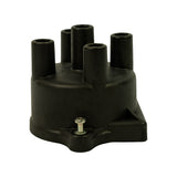 Front-left angle, lower perspective. Third screw (bottom-centre of base flange) visible. Internal bore openings of the four plug towers clearly open and clean.