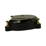 Side-on profile view of distributor cap showing low dome height, three protruding mounting ears with gold screws, and 'NISSAN' embossed text visible upside down. Cap is uniformly black.