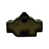 Top-down view showing amber/olive-tinted epoxy fill on coil body surface, 2-pin low-tension connector housing, and central HT tower with large-diameter rubber boot removed. Mounting clip tab visible.