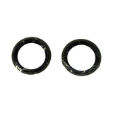 Two flat black rubber ring seals (axle/spindle oil seals) removed from packaging, shown face-on. Uniform annular profile with no visible markings.