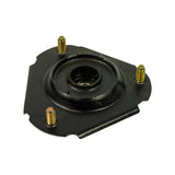 Angled view of strut mount showing underside profile; three threaded studs project fully, central strut rod bore visible, and Tenacity markings on rubber body.
