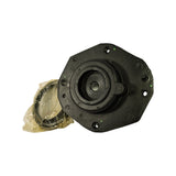 Front face of the strut mount showing six visible bolt/stud holes around the octagonal flange and the recessed central bearing pocket.