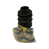 Inner CV boot upright, top-down three-quarter view showing four-convolute bellows profile and small-diameter neck opening at top. Nissan polybag with clamp hardware and grease applicator nozzle laid flat in foreground.